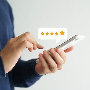 woman on phone giving 5 star rating