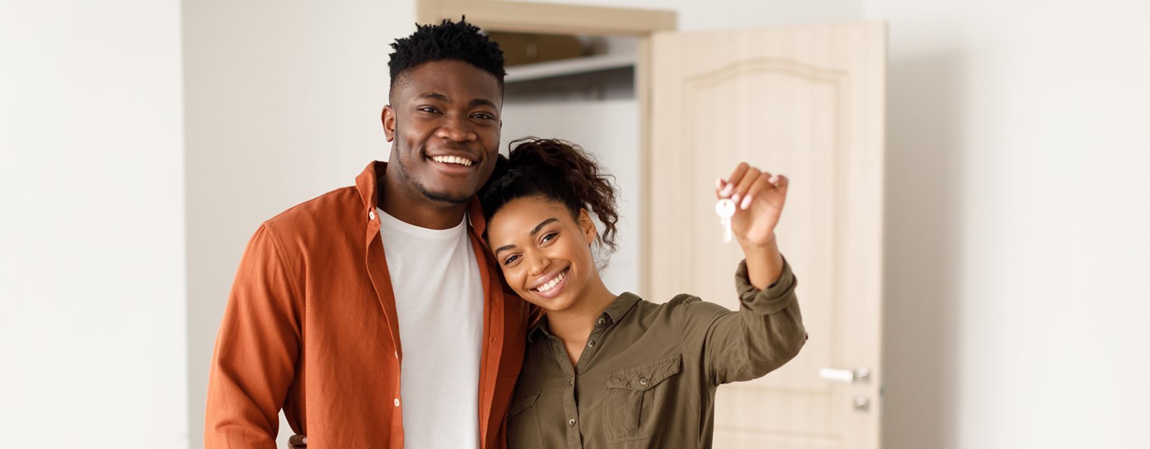 happy couple holding key