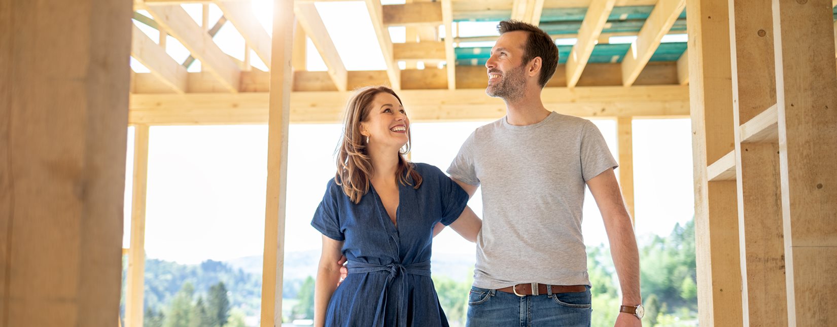 man and woman looking at construction house