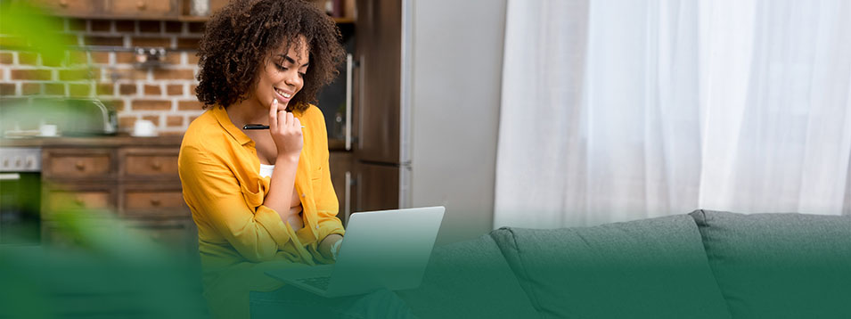 Woman looking at a laptop and smiling