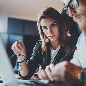 woman and man looking at laptop