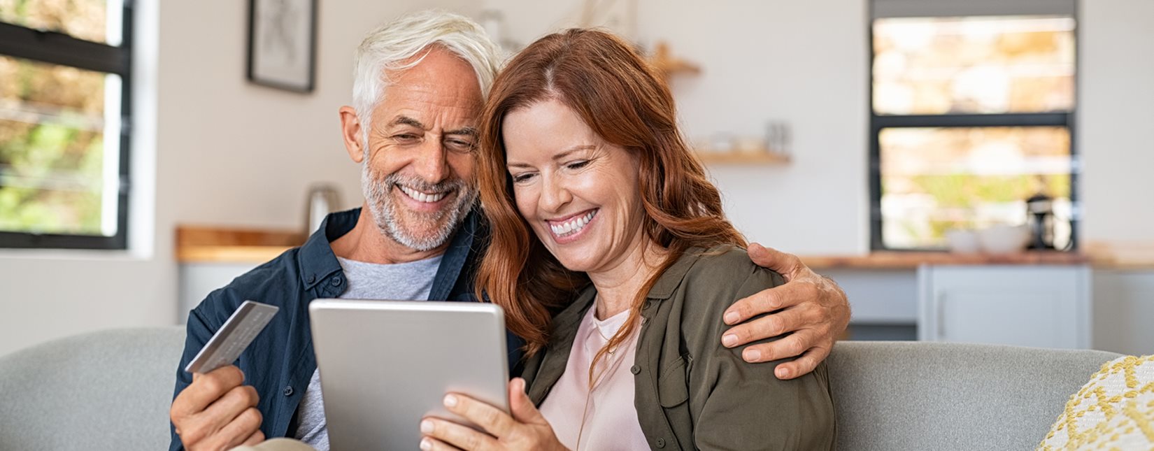 happy couple paying with card