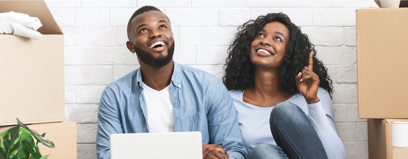 couple looking at ceiling on laptop