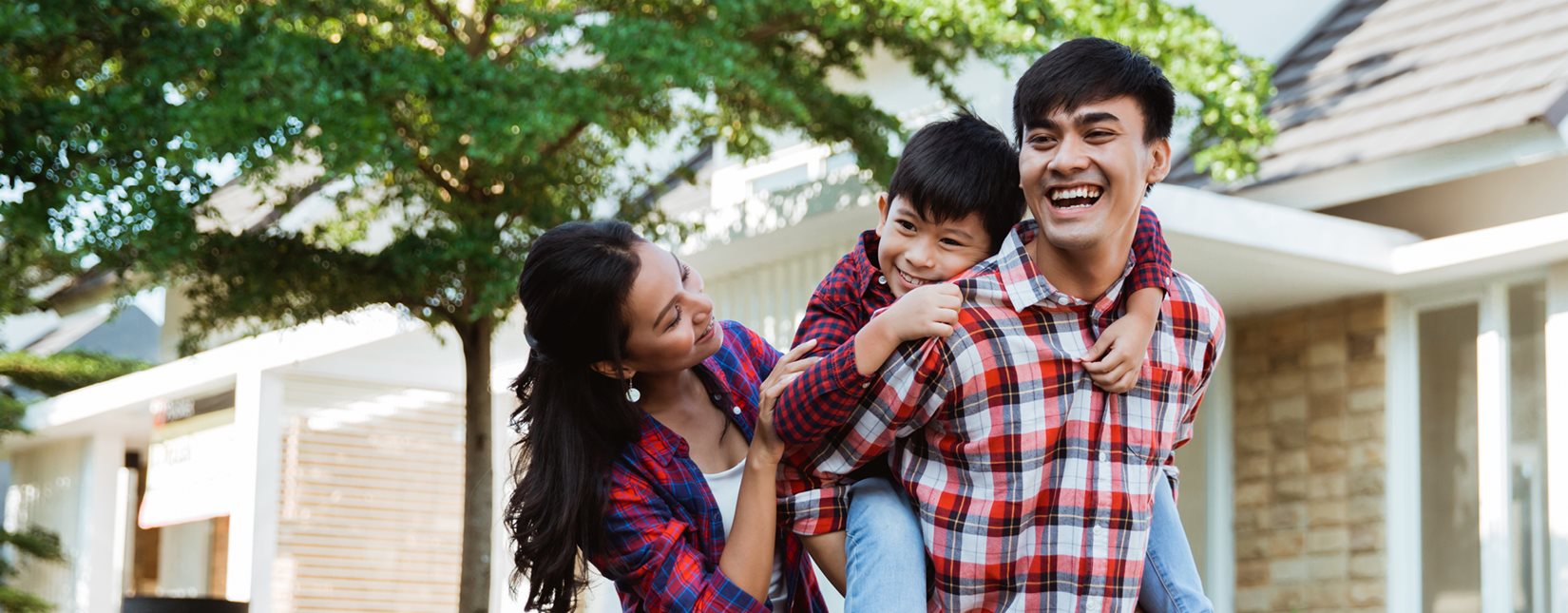 man holding son on back with mom